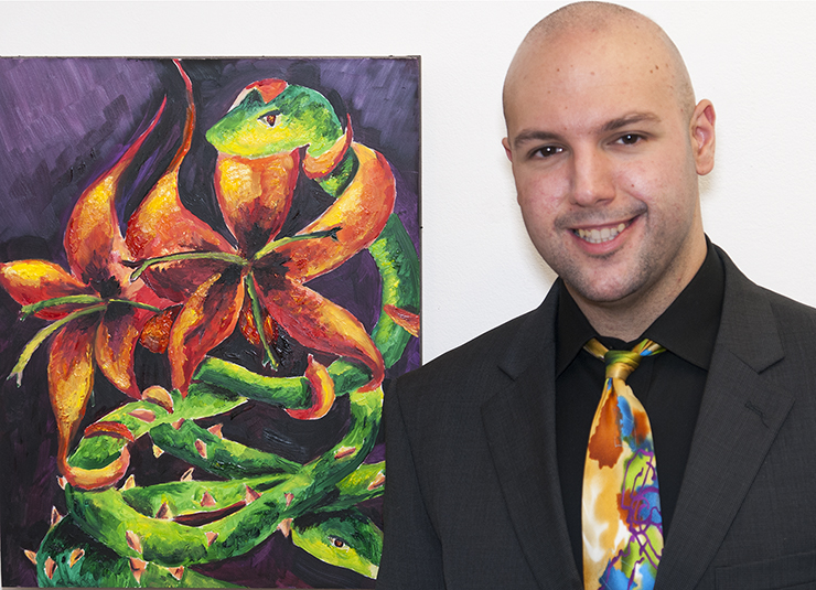 An alumni with his artwork at Alumni Art Exhibition