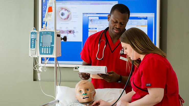 Nursing Students Performing Tests at Patient Dummy