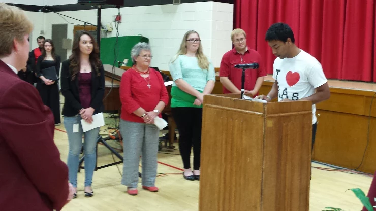Prayers of the faithful , a Caldwell student delivering speech