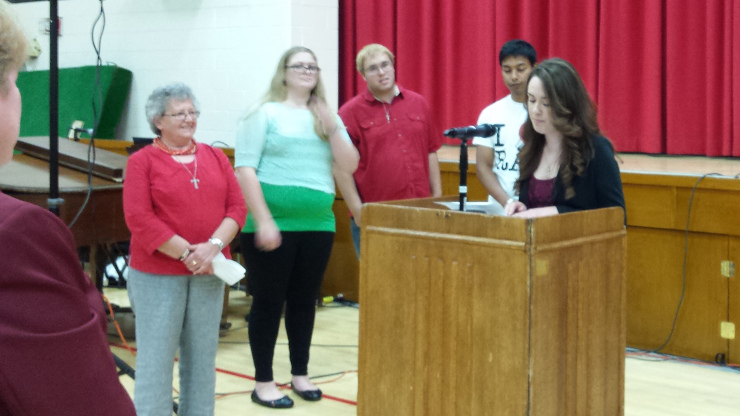 Prayers of the faithful , a Caldwell student delivering speech