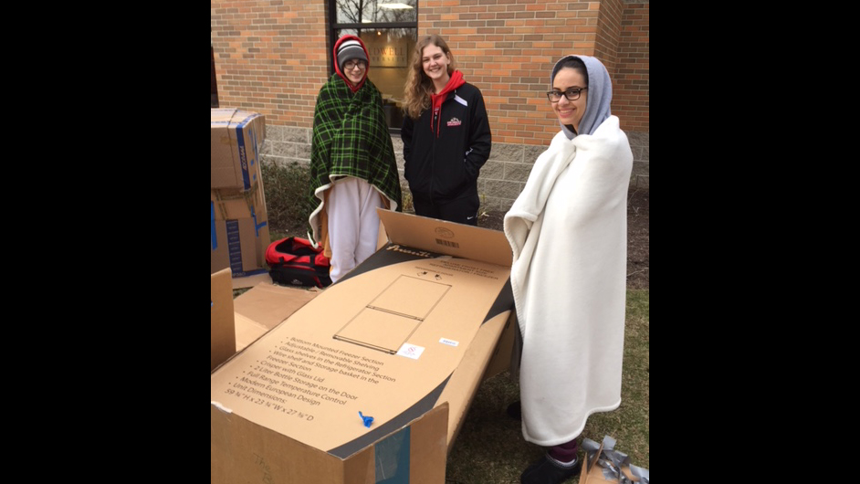 Caldwell University students cleaning up the boxes after sleeping whole night outside to support Campus Ministry project Boxtown aimed at raising awareness about homelessness.