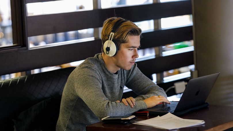 business student on headphones