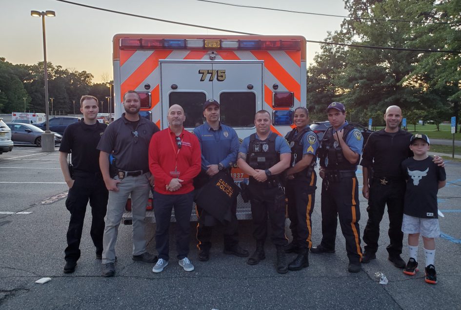 Glenn Gates, Caldwell University Executive Director of Campus Safety and Security (3rd from left) with members of the Borough of Caldwell Police Department and Essex County Sheriff Officers including Det. Sgt. Michael Capodanno and a young supporter. 