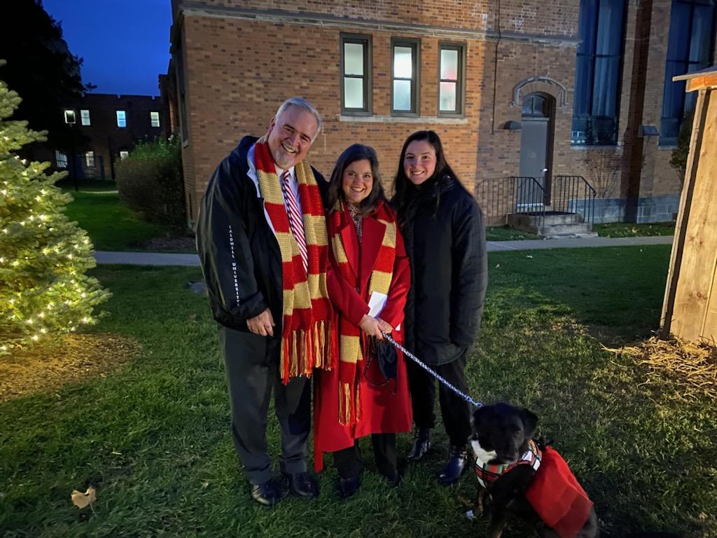 Dr. and Mrs. Whelan, their daughter Eileen, and Lucy the Canine Cougar at the annual blessing of the creche and Christmas tree lighting.