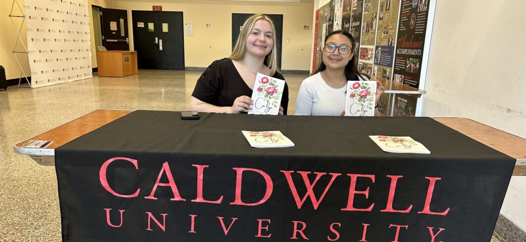 Students Kaitlin Kida and Fatima Martinez proudly display the 2023 issue of the literary magazine the Calyx, which they and their classmates produced in a new English course.