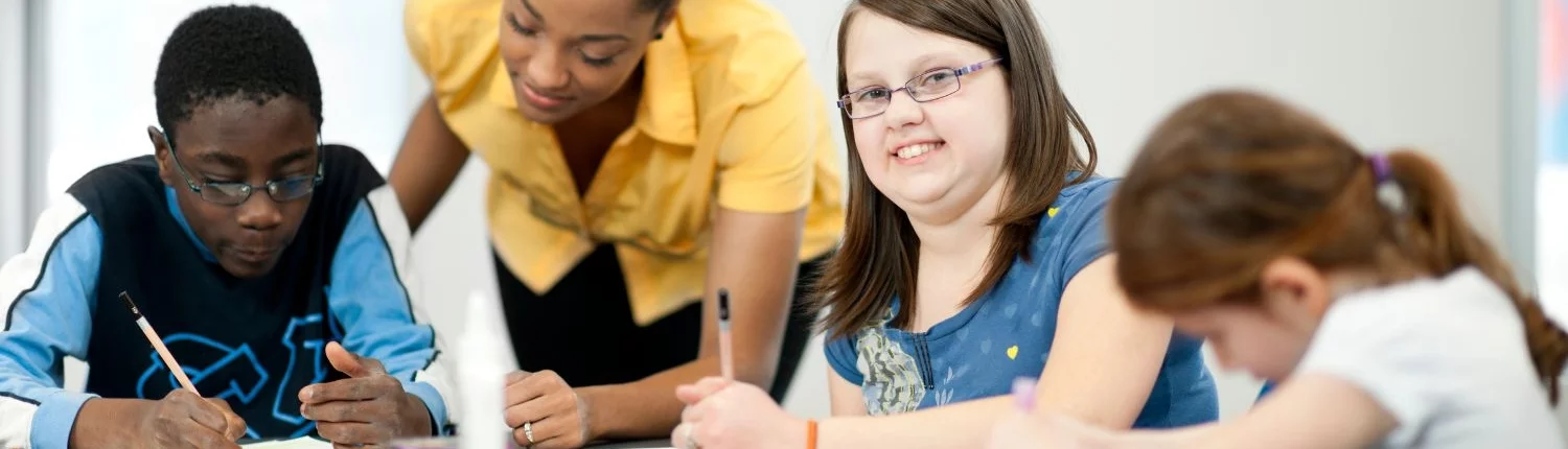 Teacher helping her students with their studies.